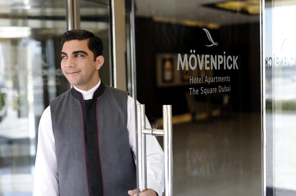 Moevenpick Hotel Apartments Al Mamzar דובאי מראה חיצוני תמונה A doorman at a hotel in Dubai